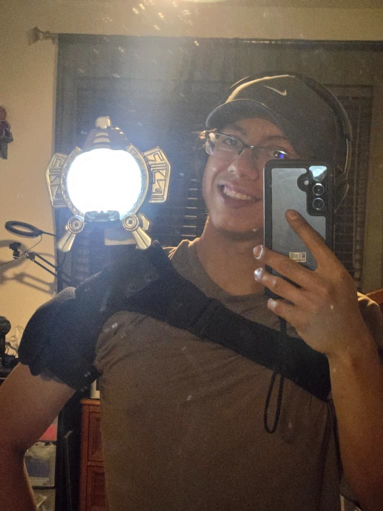 Client wearing the illuminated shoulder-mounted Max prop in a mirror selfie